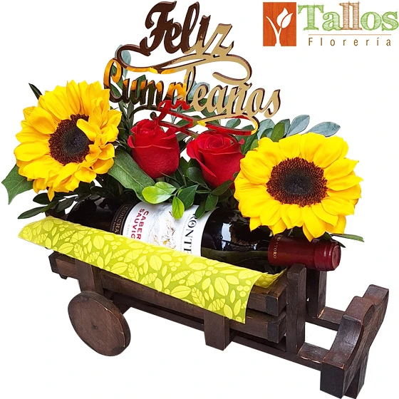 Arreglo floral con rosas rojas y girasoles con vino en base decorativa ideal para regalo de cumpleaños elegante con entrega a domicilio en Lima
